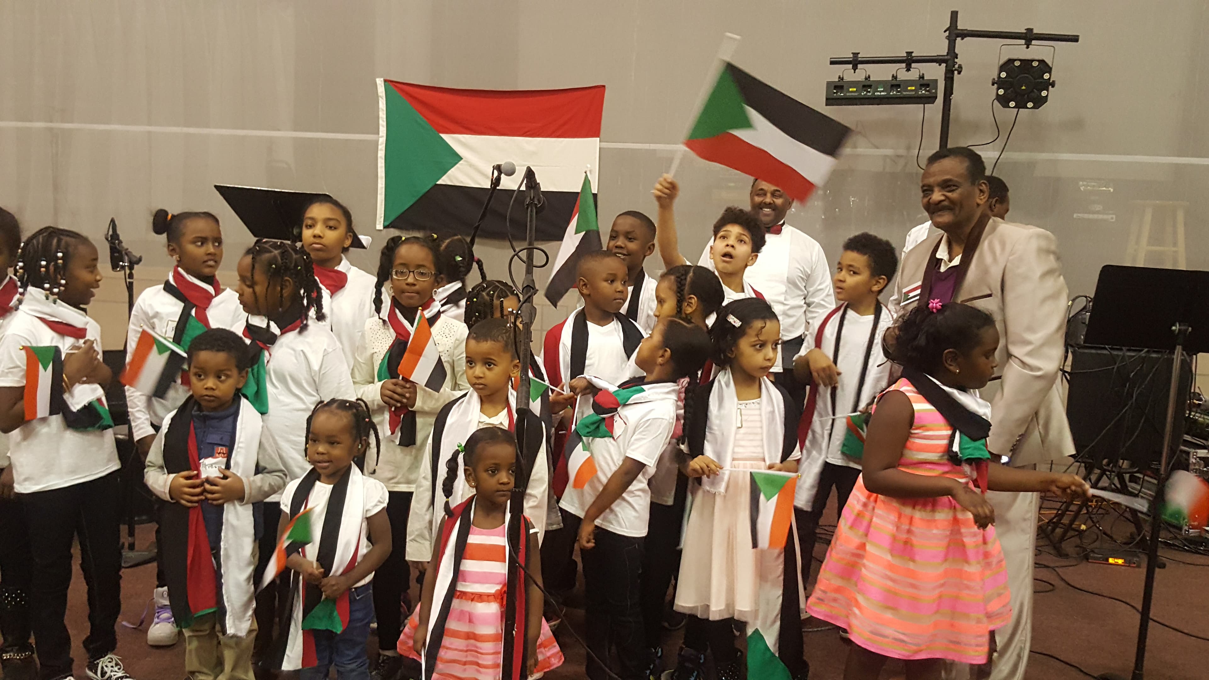 Children celebrating with Sudanese flags